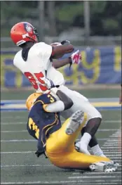  ?? STAN CARROLL/THE COMMERCIAL APPEAL ?? Olive Branch senior Devontae Davis tackles Ridgeway senior TE Marquette Murdock during Friday’s game, won by Olive Branch 38-22.