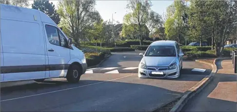  ??  ?? A customer’s car scrapes ground over the new Tesco speed hump