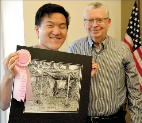  ?? Janelle Jessen/Siloam Sunday ?? Matthew Cha, a junior at Siloam Springs High School, and art teacher Ken Francis posed with the fourth place award Cha received for his pen and ink drawing in the Third Congressio­nal District Art Competitio­n.