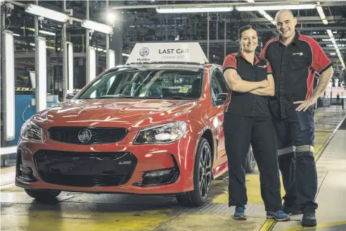  ??  ?? END OF AN ERA: Lisa Hutchinson and Andrew Wyett with the last 2017 VF Commodore sedan which was due to be driven off the production line this morning at the Elizabeth plant in South Australia.