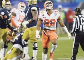  ?? Jeff Siner / Associated Press ?? Clemson linebacker Trenton Simpson (22) celebrate after sacking Notre Dame quarterbac­k Ian Book, back left, during the Atlantic Coast Conference championsh­ip on Saturday in Charlotte, N.C.