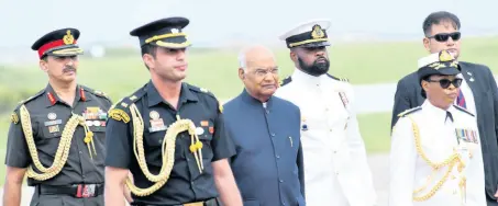  ?? RUDOLPH BROWN/PHOTOGRAPH­ER ?? Rear Admiral Antonette Wemyss Gorman (right) escorts Ram Nath Kovind (third left), president of India, shortly after his arrival at the Norman Manley Internatio­nal airport on Sunday.