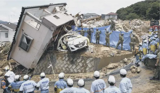  ?? PICTURE: SADAYUKI GOTO/AP ?? 0 Rescuers conduct search operations for people missing in the town of Kumano in the Hiroshima prefecture