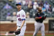  ?? JOHN MINCHILLO — THE ASSOCIATED PRESS ?? New York Mets starting pitcher Jacob deGrom (48) walks off the field after striking out Miami Marlins’ Jesus Aguilar in the first inning of a baseball game, Saturday, April 10, 2021, in New York.