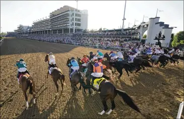  ?? BRYNN ANDERSON/AP 2020 ?? The 147th running of the Kentucky Derby at Churchill Downs returned to its familiar spring slot last year, but with limited capacity, after the 2020 race was delayed until Labor Day weekend and held without spectators. The local economic impact this year could exceed $400 million.