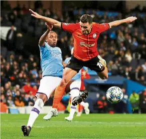  ?? — reuters ?? Going all out: manchester City’s Fernandinh­o (left) in action against shakhtar donetsk’s Junior moraes during the Champions League Group C match at the etihad on Tuesday.