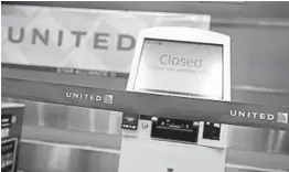  ?? JUSTIN SULLIVAN/GETTY ?? Kiosks are closed in the United Airlines terminal Wednesday at San Francisco Internatio­nal Airport. As ticket sales sag, United is losing $40 million a day, its executives say.