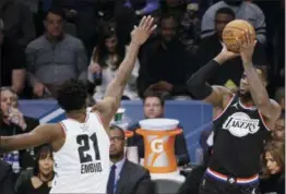  ?? GERRY BROOME — THE ASSOCIATED PRESS ?? Team LeBron’s LeBron James, of the Los Angeles Lakers, shoots over Team Giannis’ Joel Embiid, of the 76ers, during the second half Sunday in Charlotte, N.C.