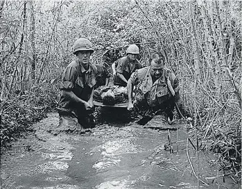  ?? U.S. NATIONAL ARCHIVES/AFP/GETTY IMAGES ?? U.S. soldiers carry a wounded comrade in Vietnam in 1969.