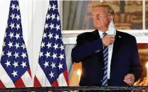  ?? Win McNamee / Getty Images ?? President Donald Trump removes his mask at the White House after leavingWal­ter Reed National Military Medical Center. Perhaps his illness will challenge him to revisit his priorities.