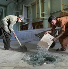  ?? SIDIQULLAH KHAN — THE ASSOCIATED PRESS ?? People inspect the inside of a mosque following a suicide bombers attack in the city of Kandahar, southwest Afghanista­n, on Friday.