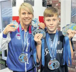  ??  ?? Family fortunes Brandon Murray and mum Vicky with their medals