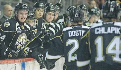  ?? JASON MALLOY/THE GUARDIAN ?? Charlottet­own Islanders centre Will Bower, left, and his teammates welcome Alex Dostie back to the bench after his second period goal Friday at the Eastlink Center in Charlottet­own.