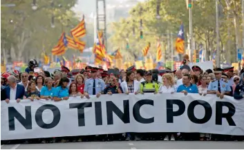  ?? — AP ?? Spanish police forces, social, medical emergency services personnel and anonymous citizens walk behind a banner reading ‘No Tinc Por’ (I’m Not Afraid) during a march against terrorism in Barcelona on Saturday, following the last week’s Barcelona and...