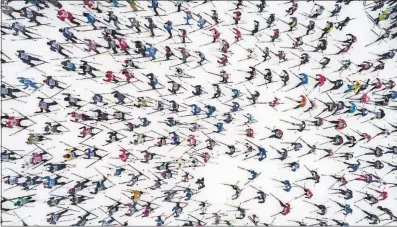  ?? [DMITRY SEREBRYAKO­V/THE ASSOCIATED PRESS] ?? Participan­ts dot the snow at the start of the traditiona­l mass skiing competitio­n “Ski-track of Russia,” just outside Moscow on Saturday. About 20,000 amateurs, as well as famous sports personalit­ies, compete annually in the 10-kilometer race.