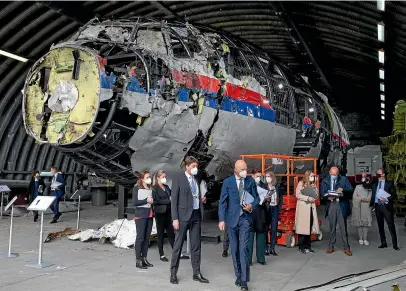  ?? ?? Judges and lawyers view the reconstruc­ted wreckage of Malaysia Airlines Flight MH17, at the Gilze-Rijen military Airbase, southern Netherland­s.