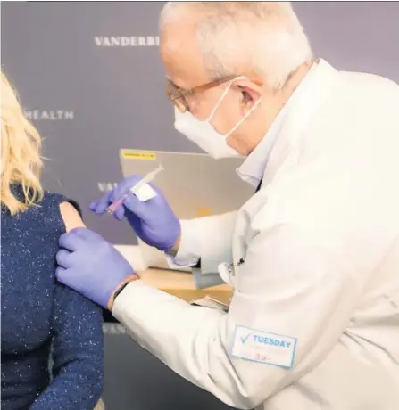  ??  ?? Statement: Dolly Parton wearing a cold-shoulder top as she receives her vaccinatio­n, and (from far left) Cathy Martin and Alana Hughes