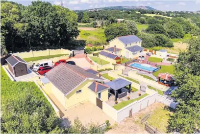  ??  ?? The huge ranch style property for sale in Swansea that comes with a small holding and outdoor swimming pool.