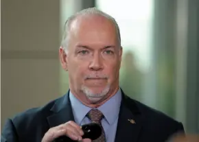  ?? CP FILE PHOTO ?? B.C. Premier John Horgan speaks to media following a meeting with ministers at the Vancouver Island Conference Centre during day two of the Liberal cabinet retreat in Nanaimo on Aug. 22.