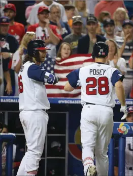  ?? David Santiago
/ el Nuevo Herald /TNS ?? United States catcher Buster Posey is congratula­ted by teammate shortstop Brandon Crawford after hitting a solo home run during the seventh inning of a World Baseball Classic first round Pool C game against Canada on Sunday, March 12, 2017, at Marlins Park in Miami, Florida.