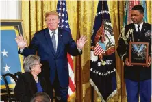  ?? Pablo Martinez Monsivais / Associated Press ?? President Donald Trump prepares to award the Medal of Honor to Pauline Conner, the widow of 1st Lt. Garlin Conner, during a White House ceremony Tuesday. Conner was recognized for his actions during World War II that resulted in 50 German deaths.