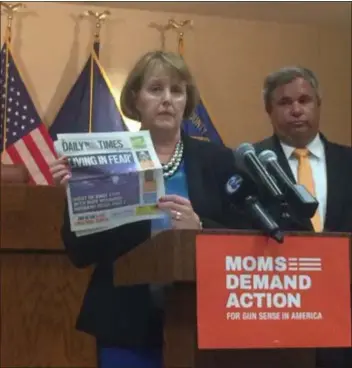  ?? KATHLEEN CAREY – DIGITAL FIRST MEDIA ?? Kathy L. Stone, executive director of the Domestic Abuse Project of Delaware County, holds up a copy of the Daily Times detailing a domestic violence incident to show the need for legislatio­n like HB 2060 that would require abusers to relinquish their firearms.