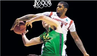  ?? STREETER LECKA~GETTY IMAGES ?? Louisville’s Chane Behanan rejects a shot by Ben Carter in the first half of the top-seeded Cardinals’ victory in the Midwest Regional semifinals Friday.