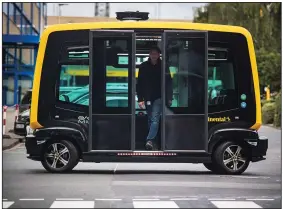  ?? Bloomberg/ANDREAS ARNOLD ?? A rider emerges from from a Cube self-driving taxi last September in Frankfurt, Germany.