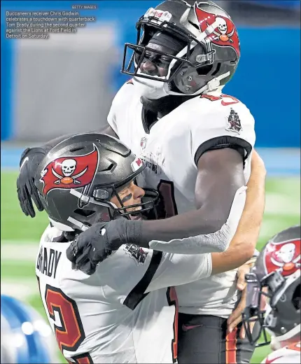  ?? GETTY IMAGES ?? Buccaneers receiver Chris Godwin celebrates a touchdown with quarterbac­k Tom Brady during the second quarter against the Lions at Ford Field in
Detroit on Saturday.