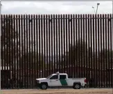  ?? AP file ?? A U.S. Customs and Border Protection vehicle is parked near a section of border wall in El Centro, Calif., on April 5.