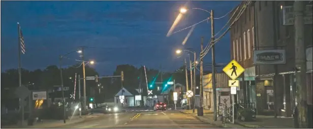  ??  ?? Dusk settles over Anna, Ill. “Sundown towns” like Anna were places where Black people were allowed in during the day to work or shop but had to be gone by nightfall. Today, some still exist in various forms, enforced now by tradition and fear rather than by rules.
(AP/Wong Maye-E)