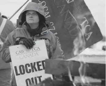  ?? DAVE CHIDLEY FOR THE TORONTO STAR ?? Brandy Damm walks the picket line Wednesday outside locomotive builder Electro-motive’s plant in London, Ont. She and 465 other workers have been locked out after refusing to accept a 50 per cent cut in pay.