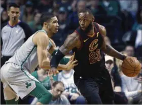  ?? MICHAEL DWYER — THE ASSOCIATED PRESS ?? LeBron James drives past the Celtics’ Jayson Tatum during the second quarter on Feb. 11 in Boston.