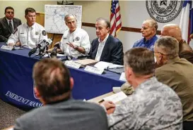  ?? Michael Ciaglo / Houston Chronicle ?? Gov. Greg Abbott, with Texas A&M Chancellor John Sharp to his left, outlines the Rebuild Texas efforts Thursday at a meeting with Fort Bend County mayors.