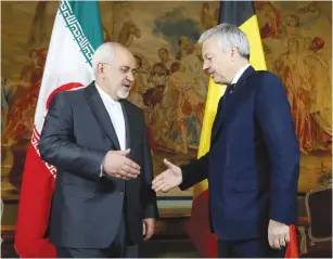  ??  ?? BELGIAN FOREIGN MINISTER Didier Reynders (right) welcomes his Iranian counterpar­t, Muhammad Javad Zarif, at Egmont Palace in Brussels earlier this month.