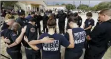  ?? ERIC GAY — THE ASSOCIATED PRESS ?? First responders join in prayer following a Veterans Day event, Saturday near the Sutherland Springs First Baptist Church, in Sutherland Springs, Texas. A man opened fire inside the church in the small South Texas community on Sunday, killing more than...