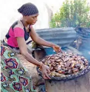  ??  ?? A woman smoke fish in Edeha village KotonKarfe Local government of Kogi state