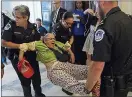  ??  ?? Anger: US Capitol police drag away a protester against the healthcare bill