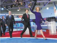  ?? Monica Almeida / New York Times ?? Carly Fiorina takes the stage at Wednesday’s Republican debate, followed by Scott Walker, Jeb Bush and Donald Trump.