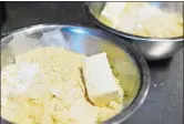  ?? SARAH GORDON/THE DAY ?? Bowls of ingredient­s, including almond flour, cream cheese and other ingredient­s, are ready to be blended as volunteers make pizza dough.