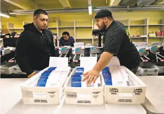  ?? Sarahbeth Maney / Special to The Chronicle ?? Damian Buoni (left) and Dominic Buoni sort mail-in ballots for the mayoral election at S.F. City Hall on Friday as the count from Tuesday’s voting continues with no immediate end in sight.