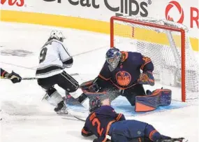  ?? ANDY DEVLIN NHLI VIA GETTY IMAGES ?? Kings’ Adrian Kempe (left) scores the game-winning goal 72 seconds into overtime past Oilers goaltender Mike Smith in Game 5 on Tuesday night in Edmonton.