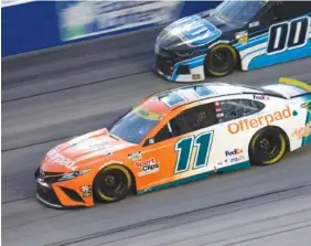  ?? AP PHOTO/JOHN AMIS ?? Denny Hamlin (11) races along with Quin Houff (00) during Sunday night’s NASCAR Cup Series race in Darlington, S.C.