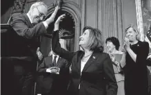  ?? Andrew Harnik/associated Press ?? House Speaker Nancy Pelosi high-fives Senate Majority Leader Chuck Schumer before she signs the Respect For Marriage Act.