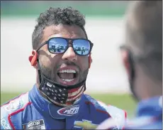  ?? MARK HUMPHREY / ASSOCIATED PRESS ?? Bubba Wallace talks to a crew member before the start of a NASCAR Cup Series auto race Sunday, July 12, 2020, in Sparta, Ky.