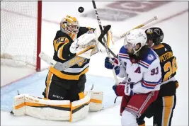  ?? GENE J. PUSKAR — THE ASSOCIATED PRESS ?? Penguins goaltender Louis Domingue blocks a shot by the Rangers' Chris Kreider but can't control the rebound that bounces over his head and into the net for the go-ahead goal.