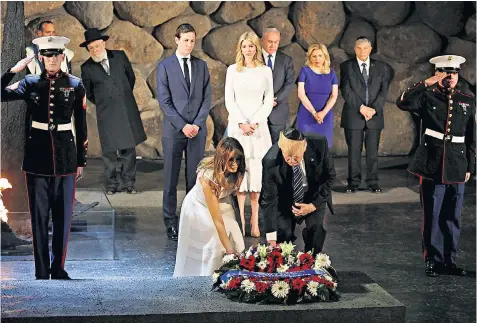  ??  ?? President Trump and First Lady Melania lay a wreath for the victims of the Nazis at the Yad Vashem Holocaust memorial in Jerusalem, watched by Ivanka Trump, also in white