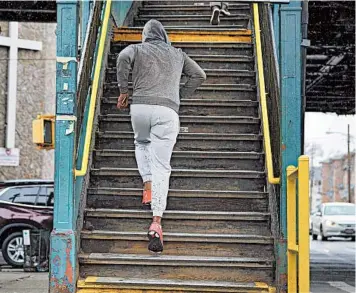  ?? NICOLE BENGIVENO/THE NEW YORK TIMES 2016 ?? A person sprints up the stairs to an elevated subway station in New York. A new study has found that intense bursts of exercise throughout the day may have surprising metabolic benefits.