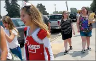  ??  ?? Freshman Katie Blinett joined the crowds leaving Lodi High School with her mother on Tuesday.