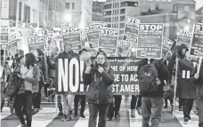  ?? JOSE LUIS MAGANA, AP ?? Demonstrat­ors march in downtown Washington Sunday before President-elect Donald Trump’s inaugurati­on Friday.